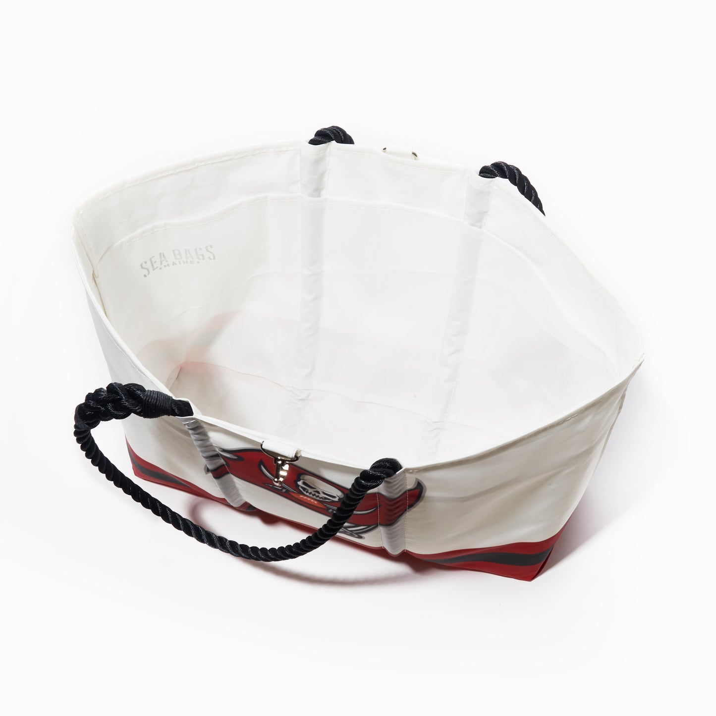 The Sea Bags Tampa Bay Buccaneers Tailgate Tote is a large, open white bag made from recycled sail cloth, featuring black rope handles and a red base, shown from above on a white background. by Sea Bags