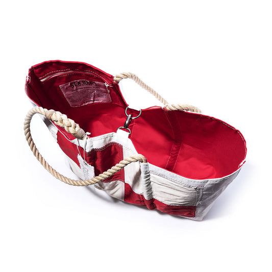 The Sea Bags Uniform Signal Flag Large Tote is a handcrafted red and white canvas bag made from vintage sail cloth, featuring rope handles, a vibrant red interior, and a leather patch label inside—its design inspired by maritime signal flags. by Sea Bags