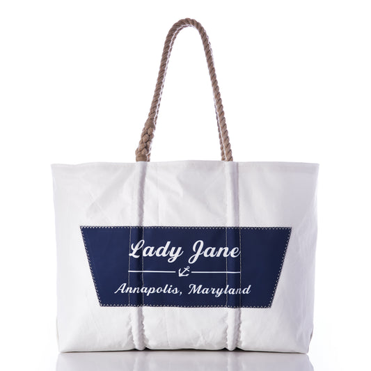 The Sea Bags Custom Boat Name Tote features sturdy rope handles and a navy blue patch on the front reading “Lady Jane, Annapolis, Maryland”—the perfect personalized accessory to bring nautical style to your daily adventures. by Sea Bags