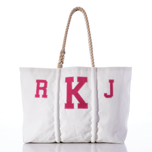 The Custom Monogram Tote by Sea Bags features pink stitched monogram letters R K J on the front, a rope handle, and is crafted from recycled sail cloth. This personalized tote bag is photographed against a white background. by Sea Bags