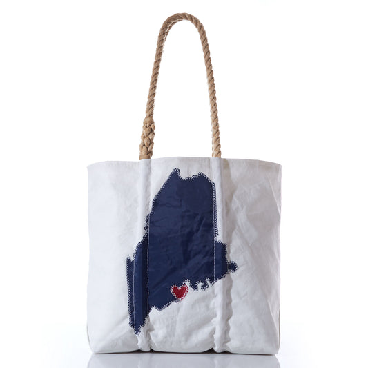 The Custom Maine Tote by Sea Bags features a white design with rope handles, a navy silhouette of Maine, and a red heart stitched near the southern coast—making it a thoughtful personalized gift for anyone who loves the Pine Tree State. by Sea Bags