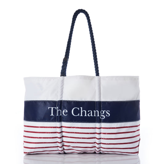 Introducing the Sea Bags Custom Mariner Stripe Tote—a white recycled sail cloth bag featuring a bold navy stripe personalized with The Changs, accented by striking red stripes along the bottom and finished with sturdy dark rope handles. This nautical-inspired tote combines eco-conscious craftsmanship with standout style. by Sea Bags