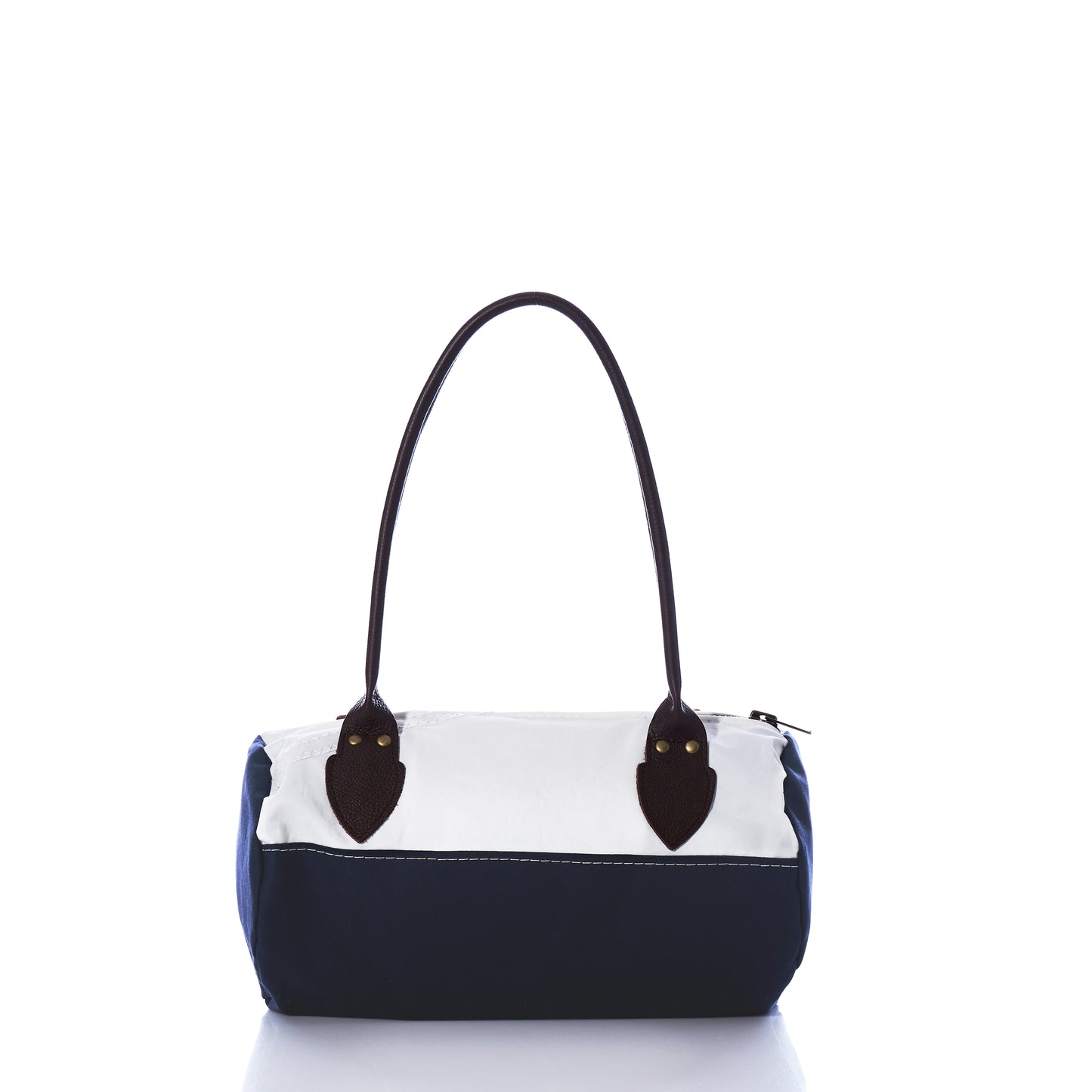The Chebeague Baguette Bag by Sea Bags features a two-tone design with a white upper section, navy blue lower section, dark handles, and a zipper closure, displayed on a white background. by Sea Bags