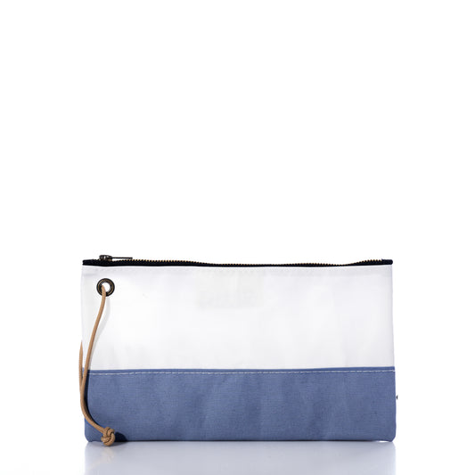 The Chambray Blue Chebeague Large Wristlet by Sea Bags is a rectangular pouch crafted from upcycled materials, featuring a white top half and a blue bottom half made from reclaimed sailcloth. It includes a black zipper and a tan wrist strap, and is displayed against a white background. by Sea Bags