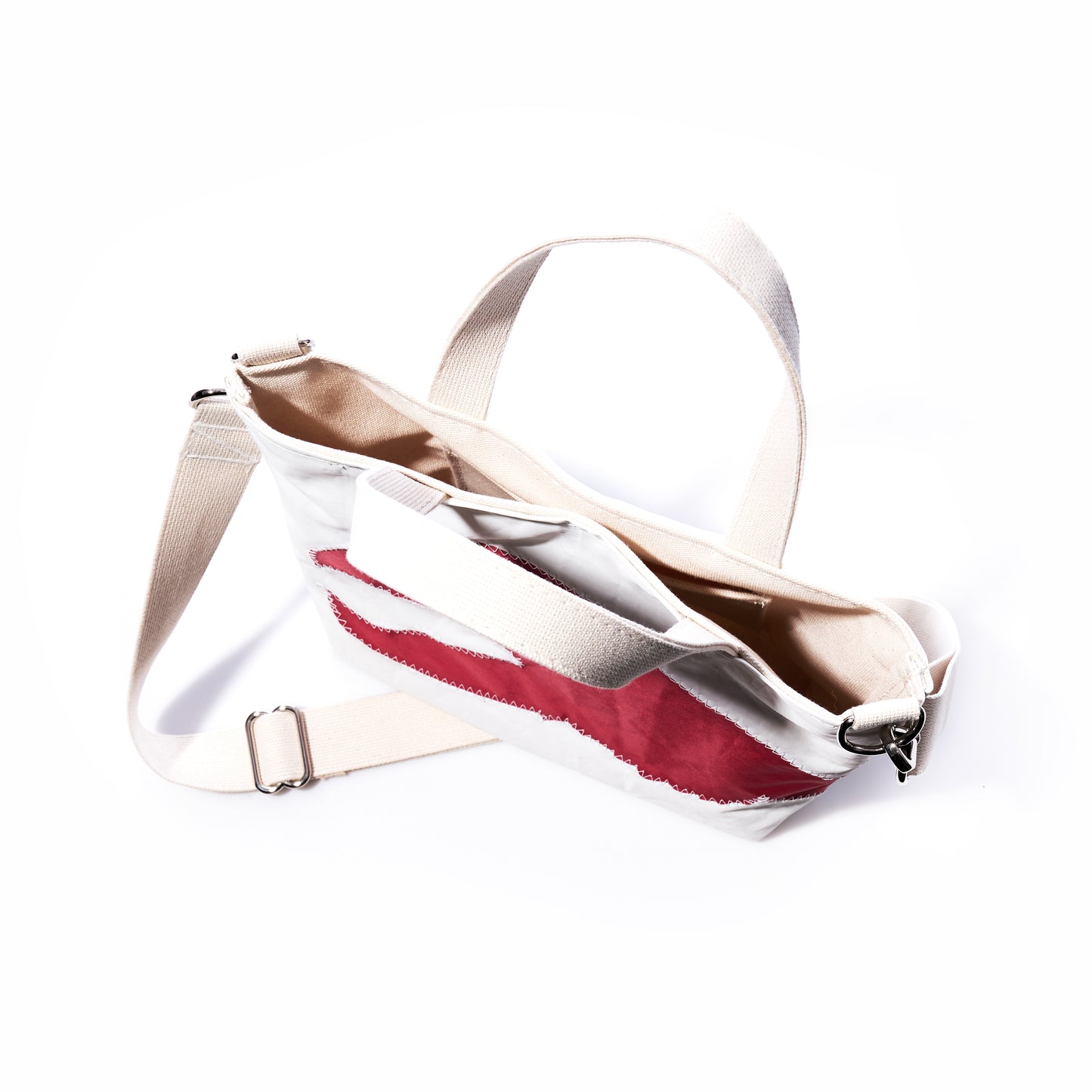 Sea Bags Red Lobster Claw Crossbody Tote is an eco-friendly white canvas bag featuring an adjustable strap and a bold red lobster claw design on the front, shown against a white background. by Sea Bags