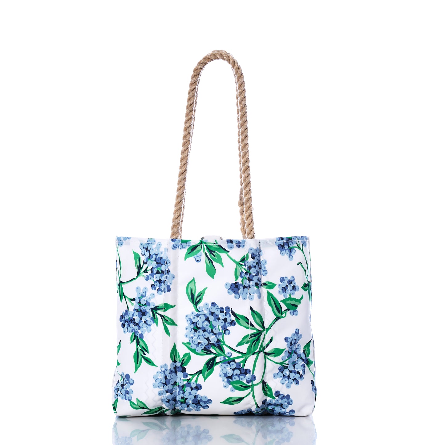 Sea Bags’ Blueberry Print Handbag features a blue and green floral pattern inspired by Maine blueberries, crafted from recycled sail cloth with two twisted rope handles, and shown against a white background. by Sea Bags