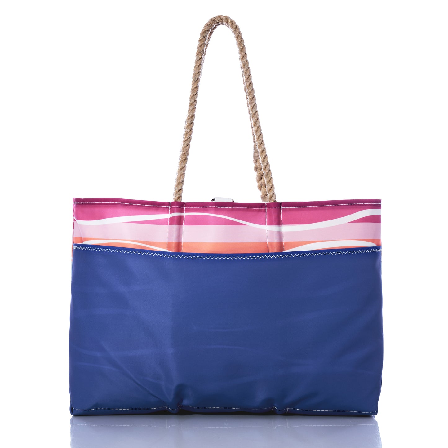 Introducing the Sea Bags Sunset Surf Ogunquit Beach Tote: a stylish tote bag with sturdy rope handles, showcasing a blue body complemented by a pink and white striped top section. Displayed against a white background, this tote is designed for convenience and features waterproof pockets to keep your essentials safe and dry. by Sea Bags