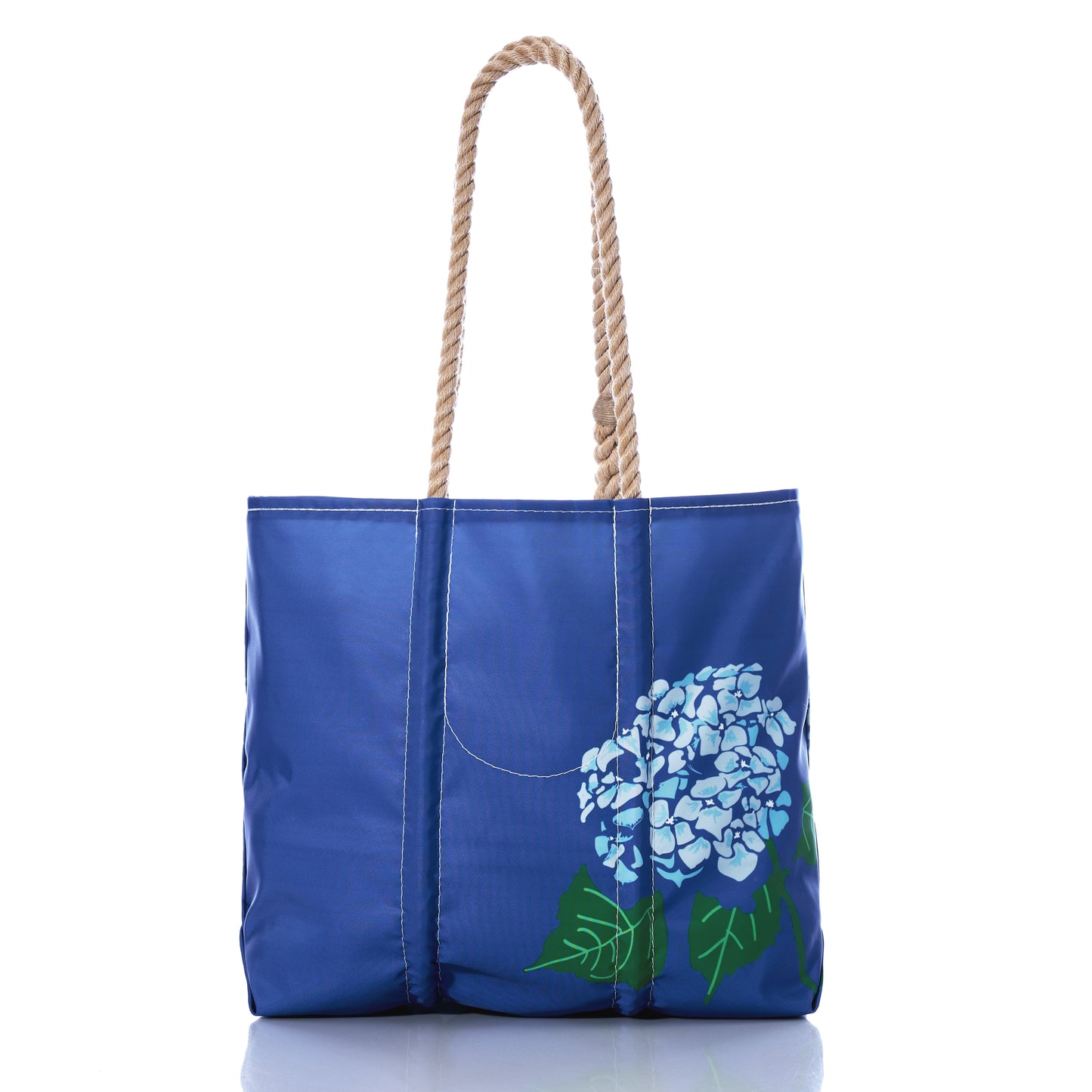 The Harbor Blue Hydrangea Medium Tote by Sea Bags features rope handles and a painted blue hydrangea flower design on the front, displayed against a white background—this charming tote evokes a refreshingly coastal feeling, perfect for sunny days by the shore. by Sea Bags