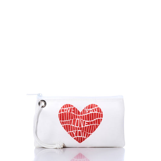 The Love Notes Wristlet by Sea Bags, crafted from recycled sailcloth, features a zippered pouch with a drawstring and a striking red mosaic heart graphic with the word LOVE in a mosaic pattern on the front. Photographed on a white background, this delightful accessory blends eco-friendly style and heartfelt design—making it a thoughtful Valentine’s Day gift. by Sea Bags