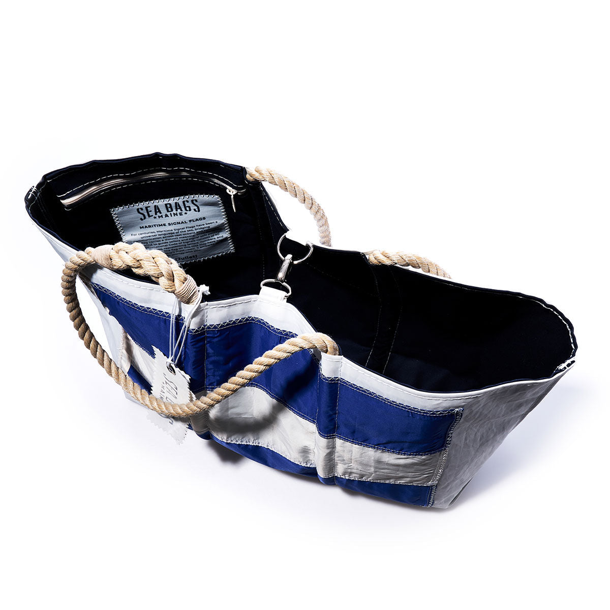 Juliett Signal Flag Large Tote by Sea Bags, a blue and white handcrafted tote bag with rope handles made from vintage sail cloth, features an interior label reading Sea Bags and is photographed from above against a white background. by Sea Bags