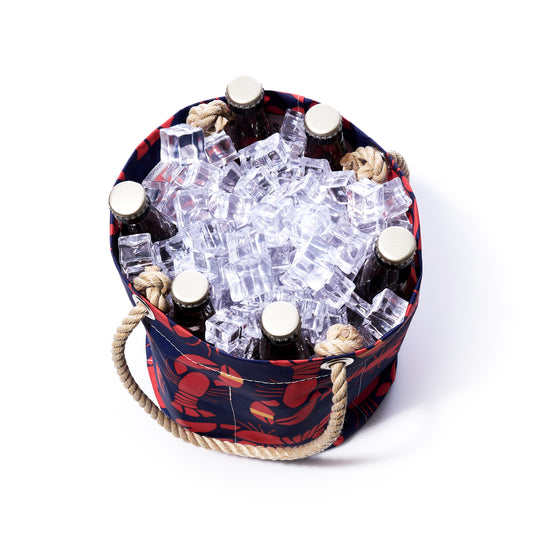 The Sea Bags Lobster Bake Beverage Bucket, styled after a classic lobster tote and featuring a sturdy rope handle, holds several bottles nestled in ice cubes, as seen from above against a white background. by Sea Bags