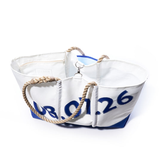 Handcrafted from recycled sailcloth, the Custom Date Ogunquit Beach Tote by Sea Bags features blue numbers, sturdy rope handles, and a metal clasp. Photographed on a white background, this personalized tote is perfect for commemorating special moments—customize yours as a unique Custom Date Ogunquit Beach Tote for an extra-special touch. by Sea Bags