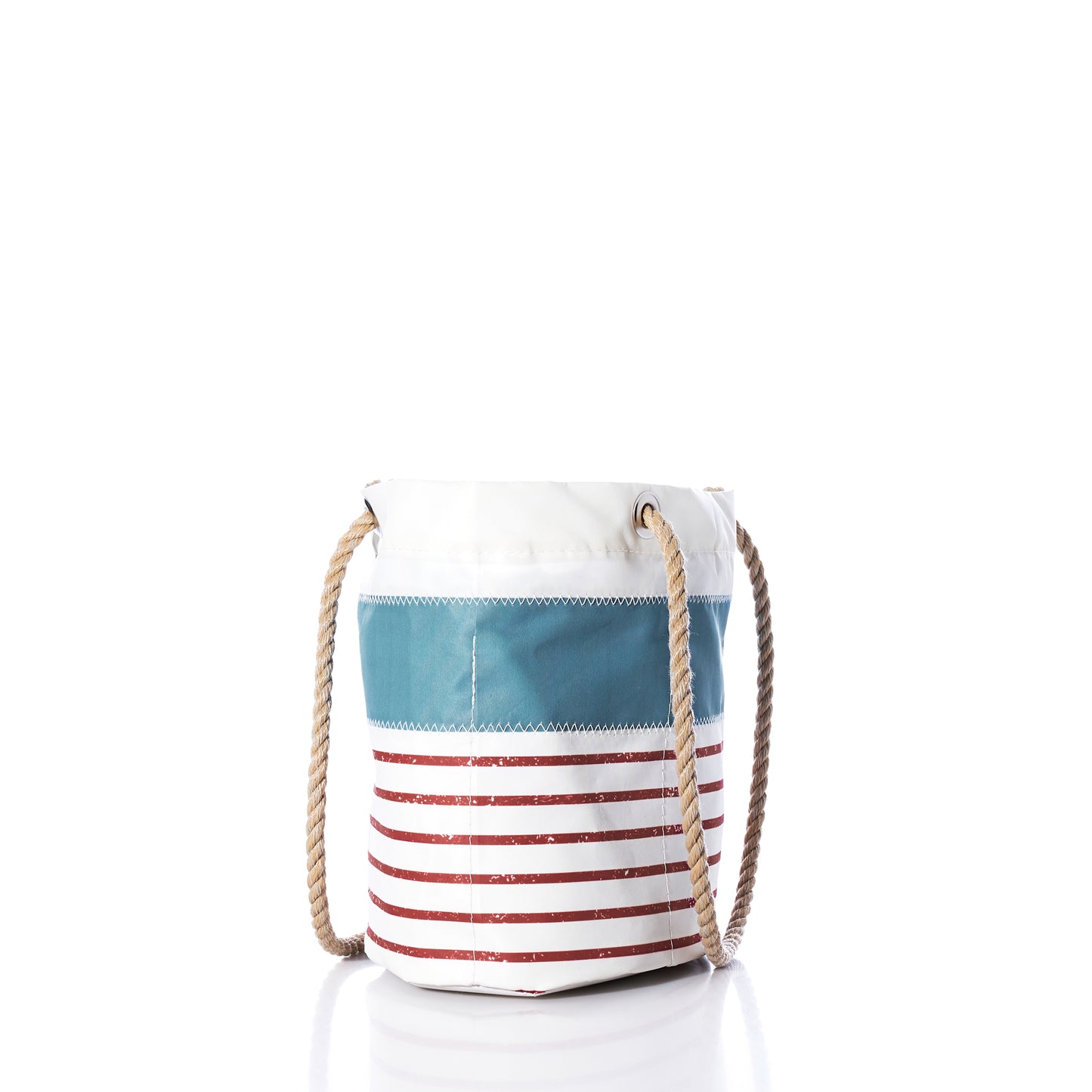 Introducing the Sea Bags Denim Blue-on-Red Mariner Stripe Essential Handbag – a round canvas bag featuring bold blue and red stripes against a clean white background, designed with sturdy rope handles on each side. This lightweight Sea Bags handbag is showcased upright on a reflective surface, set against a simple white backdrop.