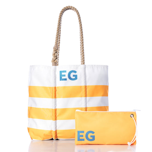 Sea Bags Custom Monogram Breton Stripe Medium Tote Large Wristlet Bundle featuring a white and yellow striped tote bag with rope handles, personalized with blue EG initials and crafted from recycled sailcloth, paired with a matching large yellow wristlet displaying the same initials.