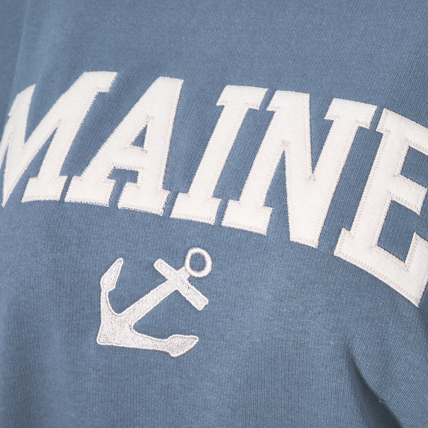Show off your Maine coastal style with the Soft As A Grape Crewneck Pullover - Denim Maine Anchor, featuring bold white MAINE lettering and a classic anchor graphic on a denim-blue crewneck. by Sea Bags