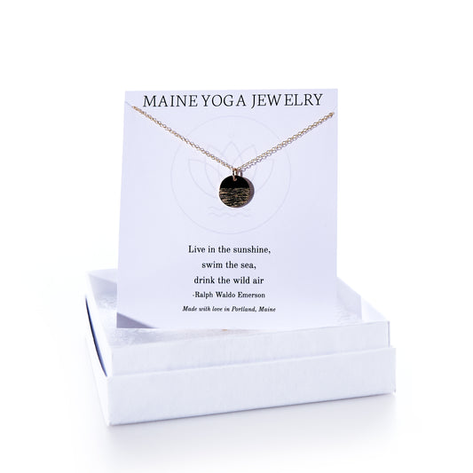 Introducing the Pendant Necklace - Horizon Gold by Maine Yoga Jewelry: this elegant gold pendant necklace features a meaningful Emerson quote on its display card and comes packaged in a white box labeled Maine Yoga Jewelry, making it a beautiful addition to any jewelry collection. by Sea Bags