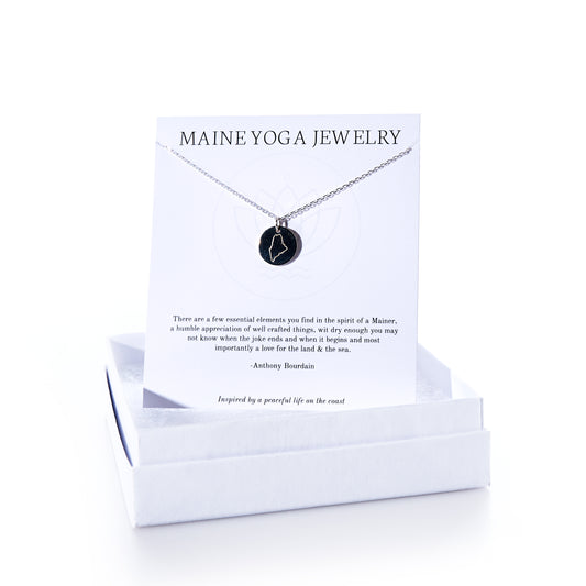 A Pendant Necklace - Silver Maine by Maine Yoga Jewelry is presented on a branded card inside an open white jewelry box, embodying the graceful style of coastal-inspired jewelry. by Sea Bags