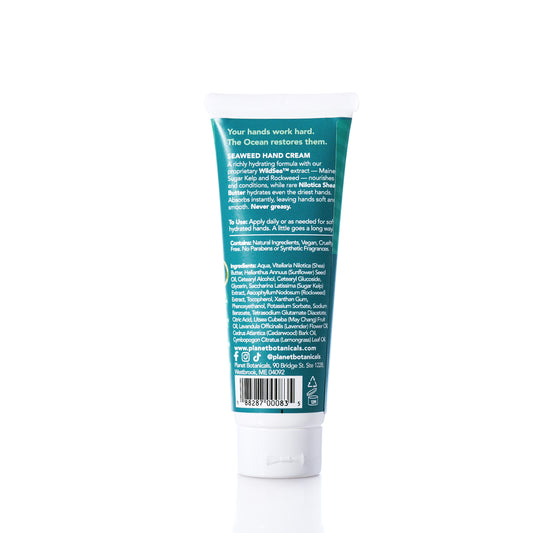 A tube of Planet Botanicals - Seaweed Hand Cream 3.4oz stands upright on a white background, with product information and ingredients shown on the back label. Infused with Nilotica Shea Butter and Sugar Kelp, this hand cream delivers hydrating nourishment for soft, revitalized hands. by Sea Bags
