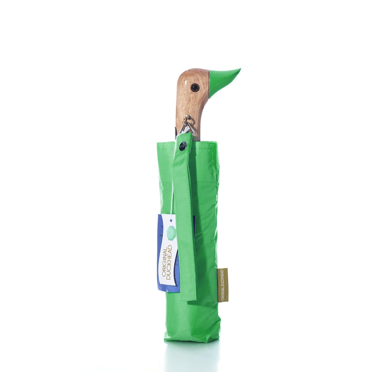 A Matcha Green Original Duck Head Umbrella by True features a wooden handle shaped like a duck’s head, partially covered with a coordinating green sleeve and adorned with two attached tags. This wind-resistant umbrella blends classic style with dependable functionality.