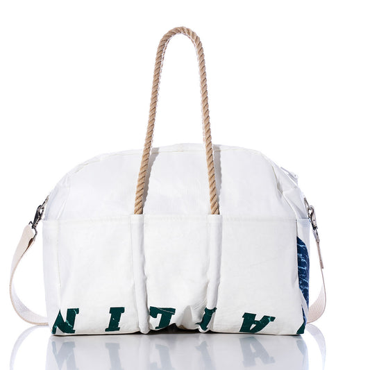 The Sea Bags Vintage Salve Sailing Weekender is a white duffel bag with hemp handles, a side strap, and green printed letters along the bottom edge, photographed against a white background—perfectly styled for your next getaway. by Sea Bags