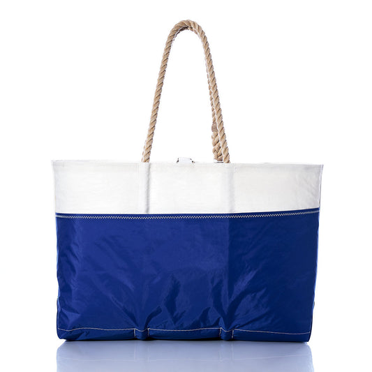 The Sea Bags Vintage Pearson 10M Ogunquit Beach Tote is a large blue and white beach bag crafted from recycled sail cloth, featuring sturdy rope handles and displayed upright against a white background. by Sea Bags