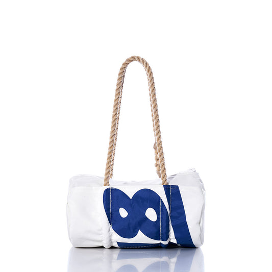 The Vintage Ideal 18 Baguette Bag by Sea Bags is a white and blue cylindrical hand-spliced rope handbag with rope handles, featuring large blue circles and a bold blue stripe on the side. by Sea Bags