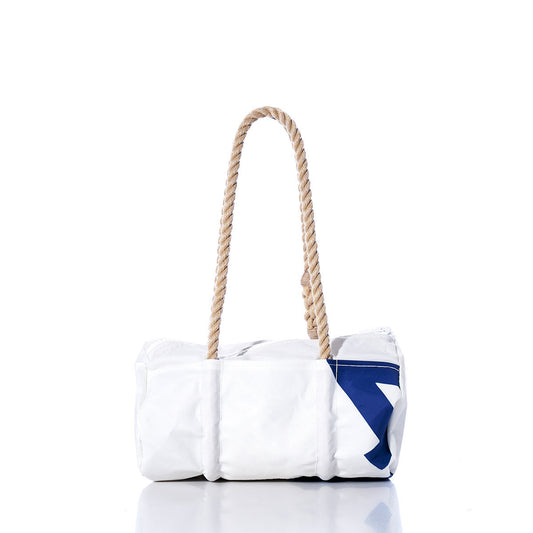 The Sea Bags Vintage 420 Baguette Bag is a white cylindrical bag made from repurposed sails, featuring a navy geometric design and hand-spliced hemp rope handles, shown against a white background. by Sea Bags