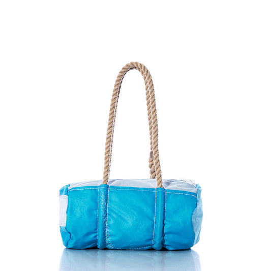 The Sea Bags Vintage Blue Baguette Bag is a small, rectangular tote crafted from recycled sails in blue and white, featuring thick hand-spliced hemp rope handles and displayed on a reflective white background. by Sea Bags
