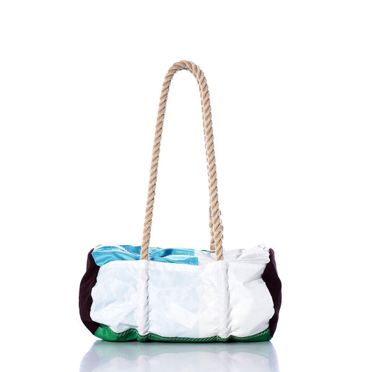 The Sea Bags Vintage Green Multicolor Baguette Bag is a rectangular tote crafted from recycled sail material, featuring a bold patchwork design in white, green, and blue with two thick hemp rope handles; pictured on a reflective surface against a white background. by Sea Bags