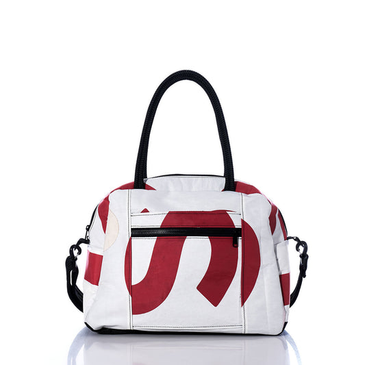 Sea Bags Vintage US Essential Weekender Travel Bag—a white carryon featuring bold red abstract patterns, black double handles, a front zip pocket, and side clasps—is shown on a reflective white surface. by Sea Bags