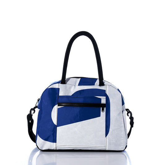 The Sea Bags Vintage US Essential Weekender Travel Bag is a medium-sized bag with two handles, showcasing a blue and white geometric design. It features a front zipper pocket, trolley sleeve for easy attachment to luggage, and a detachable shoulder strap—making it the ideal compact carryon. Shown on a white background. by Sea Bags