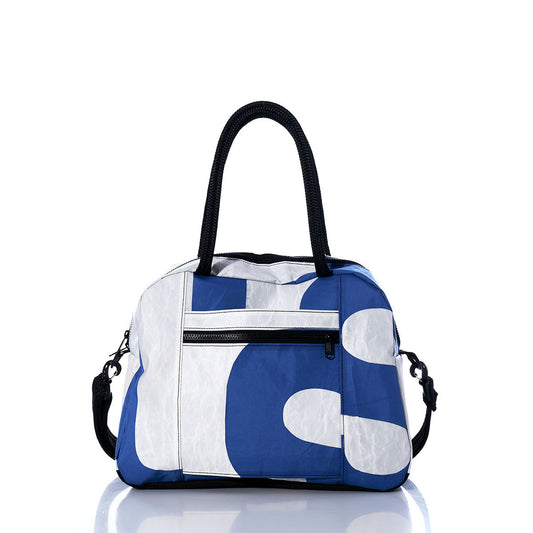 The Sea Bags Vintage Blue and White Essential Weekender Travel Bag, featuring black handles, a front zippered pocket, and a detachable shoulder strap, is photographed against a white background. by Sea Bags