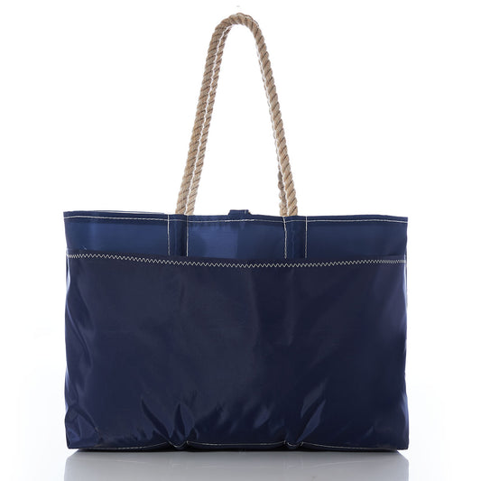 The White on Navy Sand Dollar Ogunquit Beach Tote by Sea Bags is a spacious navy blue bag made from recycled sail cloth, featuring sturdy beige rope handles. Photographed against a plain white background, this eco-friendly tote is ideal for the beach or everyday outings. by Sea Bags