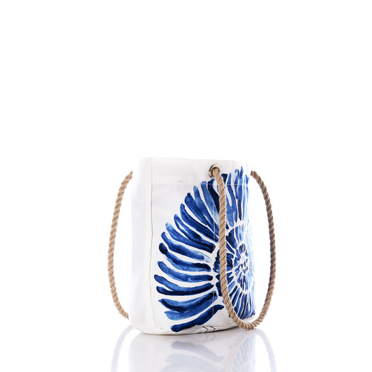 Sea Bags Nautilus Print Essential Handbag, crafted by hand from recycled sail cloth, features a blue nautilus shell design on white canvas and two sturdy rope handles for a sustainable and stylish accessory, shown photographed on a white background with its reflection beneath. by Sea Bags