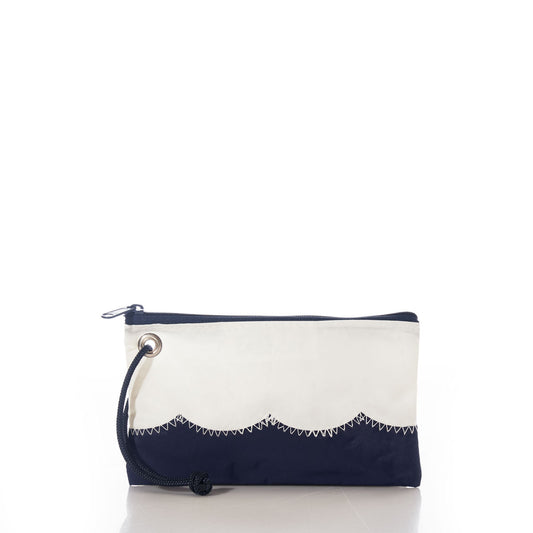 The Wavy Seas Wristlet by Sea Bags features a navy blue and white zigzag pattern, a black zipper, and a black cord loop on the left side. Displayed against a white background, this sustainable accessory embodies classic nautical style with vibrant ocean-inspired energy. by Sea Bags