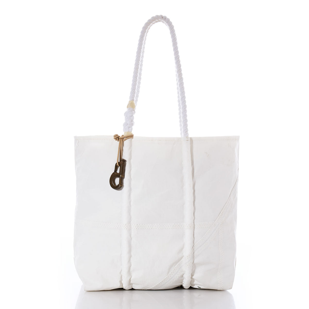 White tote bag with two rope handles and a Vintage Sailmakers Hardware brass jib hank attached near the top, displayed against a plain white background. by Sea Bags