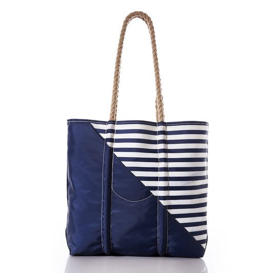 The Breton Stripe White Anchor Medium Tote by Sea Bags, handcrafted in Portland from recycled sail cloth, features navy blue and white nautical stripes with rope handles and is displayed on a white background. by Sea Bags