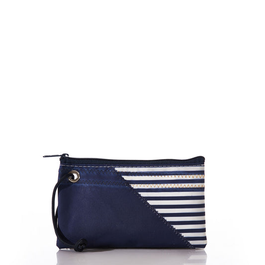 Introducing the Sea Bags Breton Stripe White Anchor Wristlet—a handcrafted navy blue zippered pouch with a convenient wrist strap. This stylish accessory features diagonal white and navy striped accents, zigzag stitching on a white background, and offers a chic nautical touch for carrying your everyday essentials. by Sea Bags