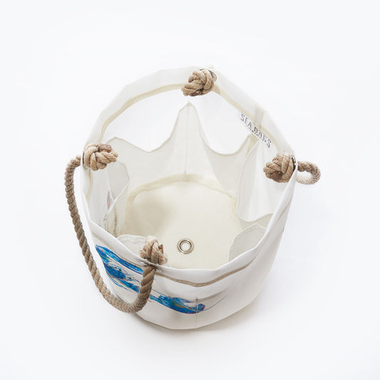The Multicolor Lobster Beverage Bucket by Sea Bags is a white canvas bucket bag made from recycled sail cloth, featuring rope handles, a metal eyelet at the bottom, and a vibrant lobster design—perfect as a stylish beverage tote—shown from above against a white background. by Sea Bags