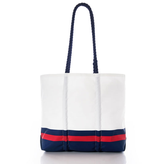 Showcased on a white background, the Sea Bags New England Patriots Medium Tote features navy blue rope handles and blue and red horizontal stripes near the base. Crafted from recycled sail cloth, this versatile bag is perfect for fans looking to display their New England Patriots pride with sustainable style. by Sea Bags