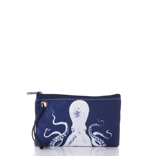 The Sea Bags White on Navy Octopus Wristlet is a small pouch crafted from recycled sails, featuring a striking white octopus graphic on navy blue, a left-side wrist strap, and eye-catching nautical style—displayed against a white background. by Sea Bags