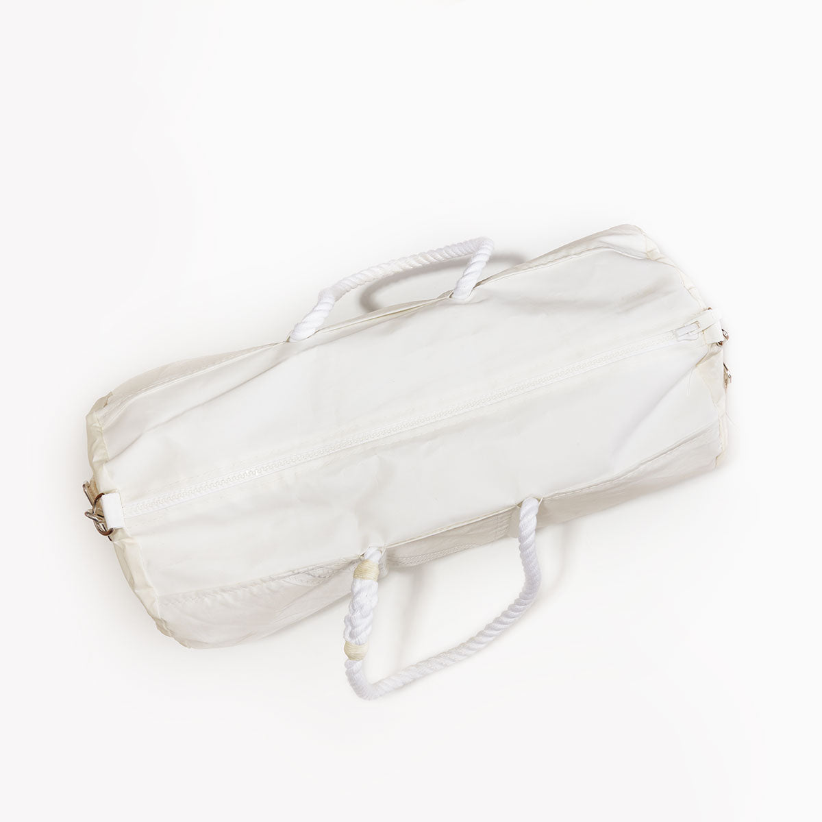 A navy vertical striped cylindrical duffel bag from Sea Bags, crafted from recycled sail cloth and featuring a durable marine grade zipper closure with two white rope handles, photographed on a plain white background. by Sea Bags