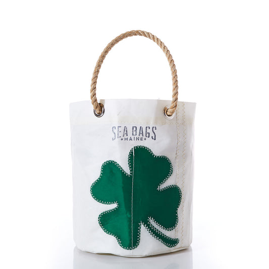 The Four Leaf Clover Beverage Bucket Bag by Sea Bags is crafted from recycled sail cloth with rope handles, featuring a large green four-leaf clover patch and SEA BAGS MAINE printed above. by Sea Bags