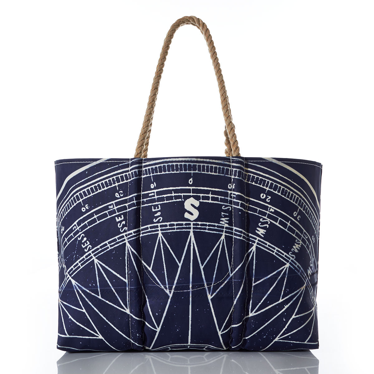 Introducing the Navy True North Large Tote by Sea Bags—a durable and eco-friendly bag crafted from recycled sailcloth. Featuring striking white geometric and compass rose designs, a bold white “S” logo at the center, and sturdy rope handles, this versatile nautical tote makes an ideal gift for ocean lovers. by Sea Bags