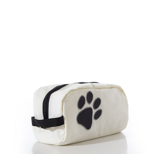 The Paw Print Toiletry Bag by Sea Bags is a white zippered pouch featuring a black paw print design on the side, crafted from recycled sail cloth and displayed against a plain white background—making it an ideal travel kit for dog lovers. by Sea Bags