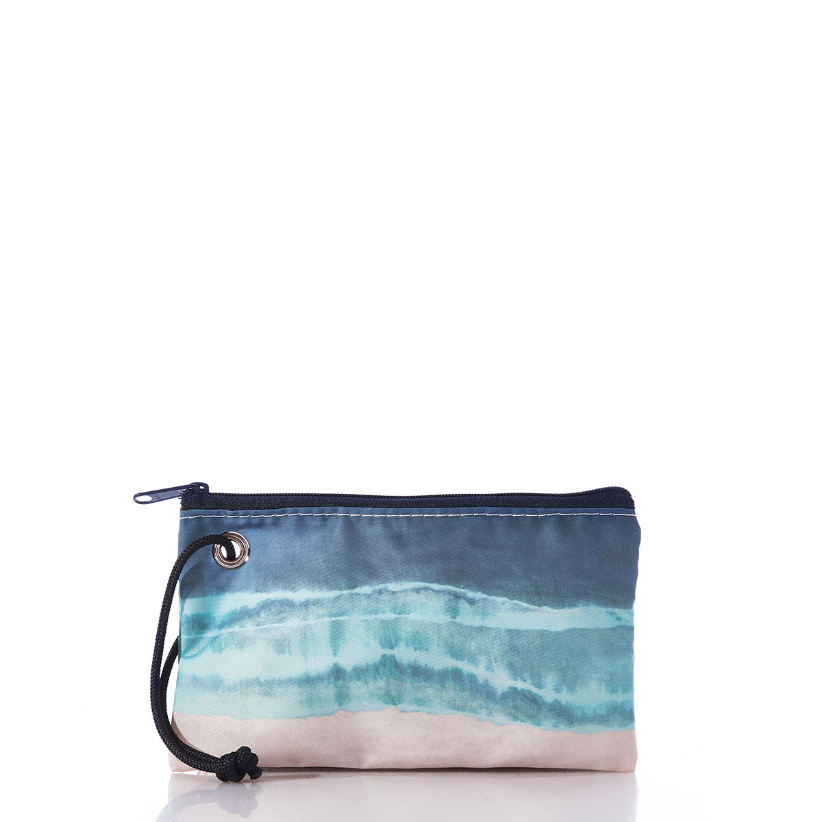 The Shoreline Tie Dye Wristlet by Sea Bags is a small zippered pouch with a wrist strap, showcasing a design reminiscent of blue ocean waves and sandy shores. Crafted from recycled sails, it is displayed against a white background. by Sea Bags