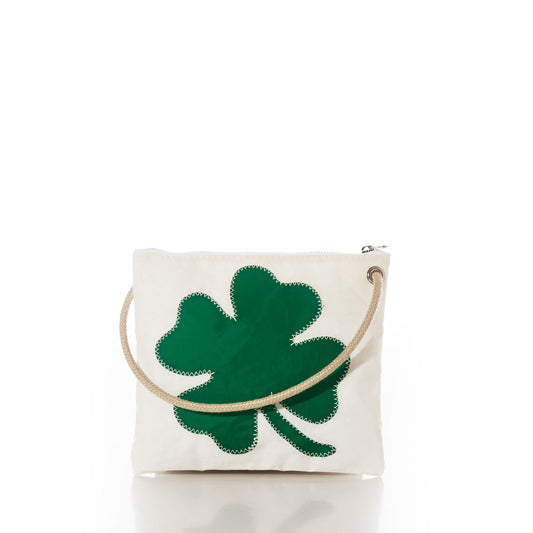 Sea Bags Four Leaf Clover Slim Crossbody—crafted from durable sail cloth, this white zippered pouch features a green four-leaf clover design and a rope handle, providing a sleek and stylish alternative to a traditional handbag, shown here on a plain white background. by Sea Bags