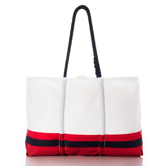 The Kansas City Chiefs Tailgate Tote by Sea Bags is a white tote bag featuring navy rope handles and bold red and navy stripes at the bottom, showcased on a plain white background. Made from recycled sail cloth, this durable and eco-friendly bag is perfect for game day tailgates or everyday adventures. by Sea Bags