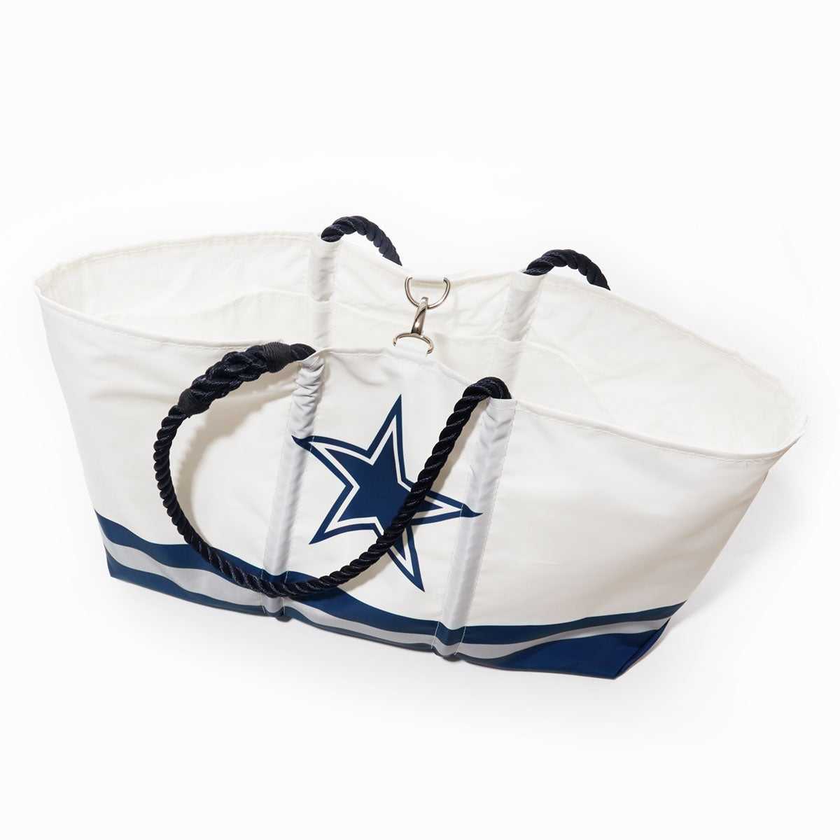The Sea Bags Dallas Cowboys Tailgate Tote features a white canvas design with navy handles, blue stripes along the bottom, and a large blue outlined star on the side—ideal for any Dallas Cowboys fan. Photographed against a plain white background, this stylish tote is crafted from recycled sail cloth, making it a perfect eco-friendly choice for football enthusiasts. by Sea Bags