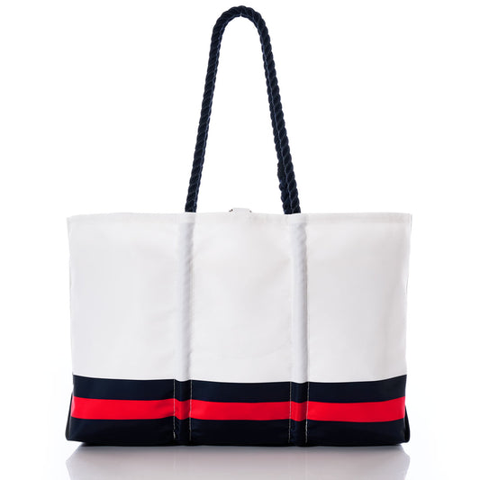 The Houston Texans Tailgate Tote by Sea Bags is a large white recycled sail cloth bag with two dark rope handles, accented with navy and red horizontal stripes near the base—a perfect accessory for Texans fans. by Sea Bags